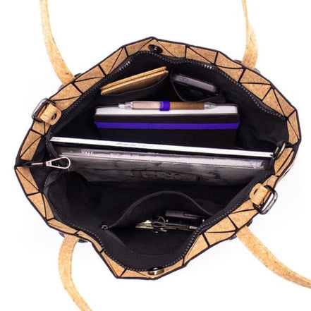 Geometric-patterned handbag with a strap, open to reveal its interior compartments.