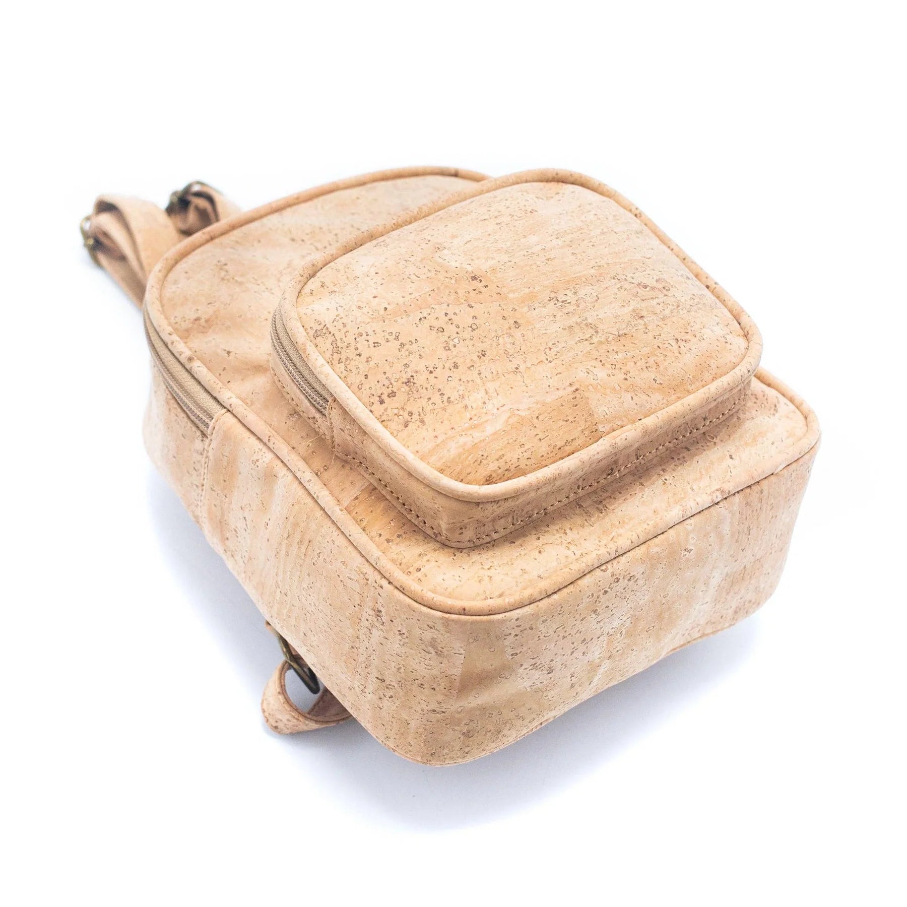 Angled view of natural cork mini backpack showing compact structure