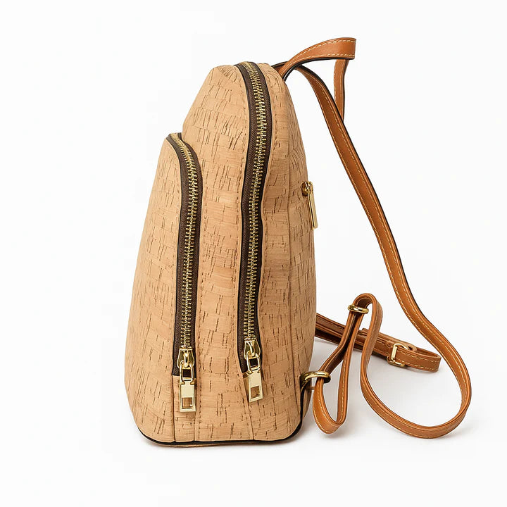 Close-up side view of cork backpack with two gold zipper compartments