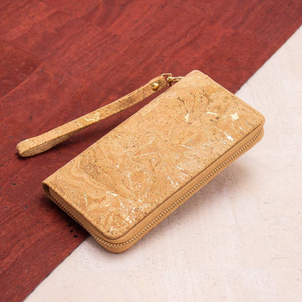 Golden accent cork wristlet wallet displayed on red and cream background