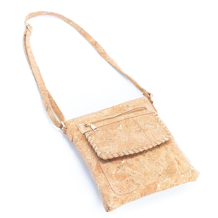 Angled view cork crossbody purse with gold hardware