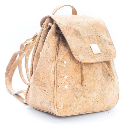 Angled view of the golden marbled cork backpack with drawstring closure