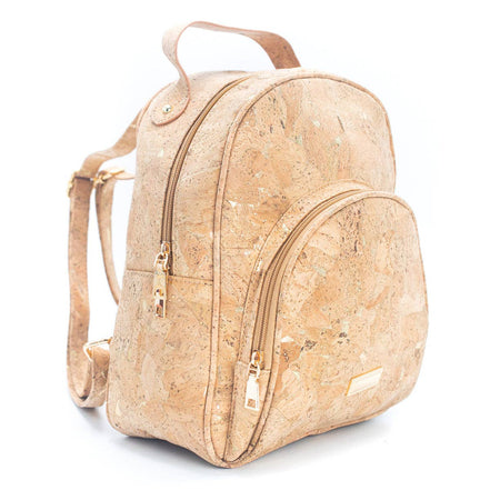 Model wearing molten gold cork vegan backpack over shoulder