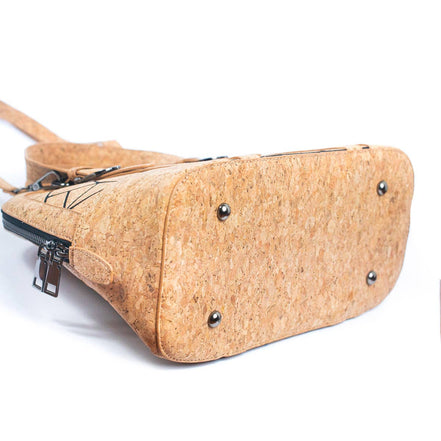 Bottom of cork handbag showing four protective rivets