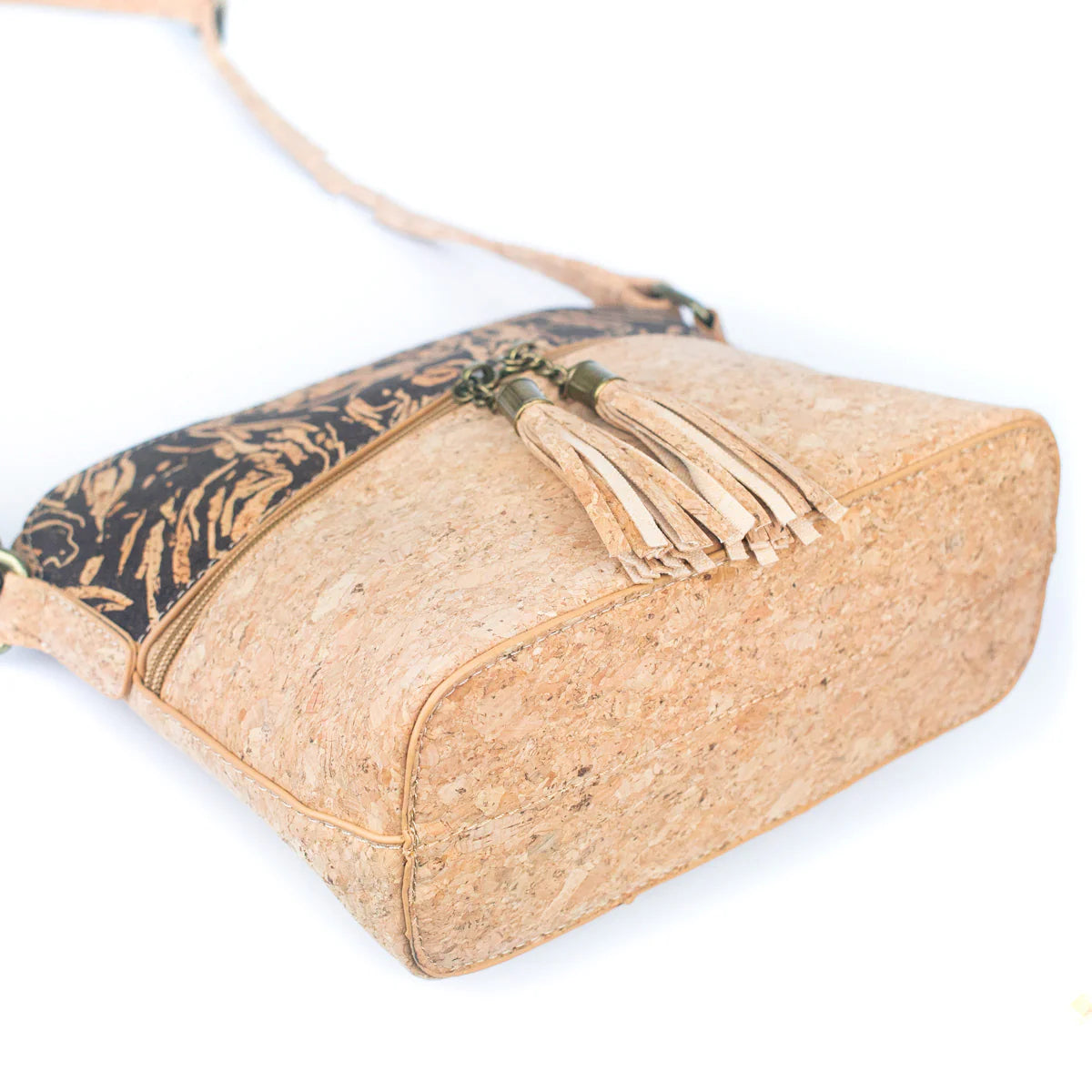 Cork handbag with floral pattern and tassel on a white background