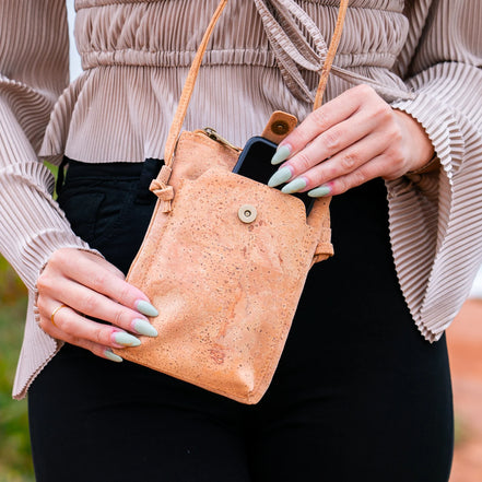 A compact &amp; stylish cork crossbody phone bag designed with gold flakes in the cork for those grab-and-go days. 