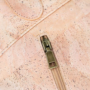 Close up of antique brass hardware on high end cork handbag