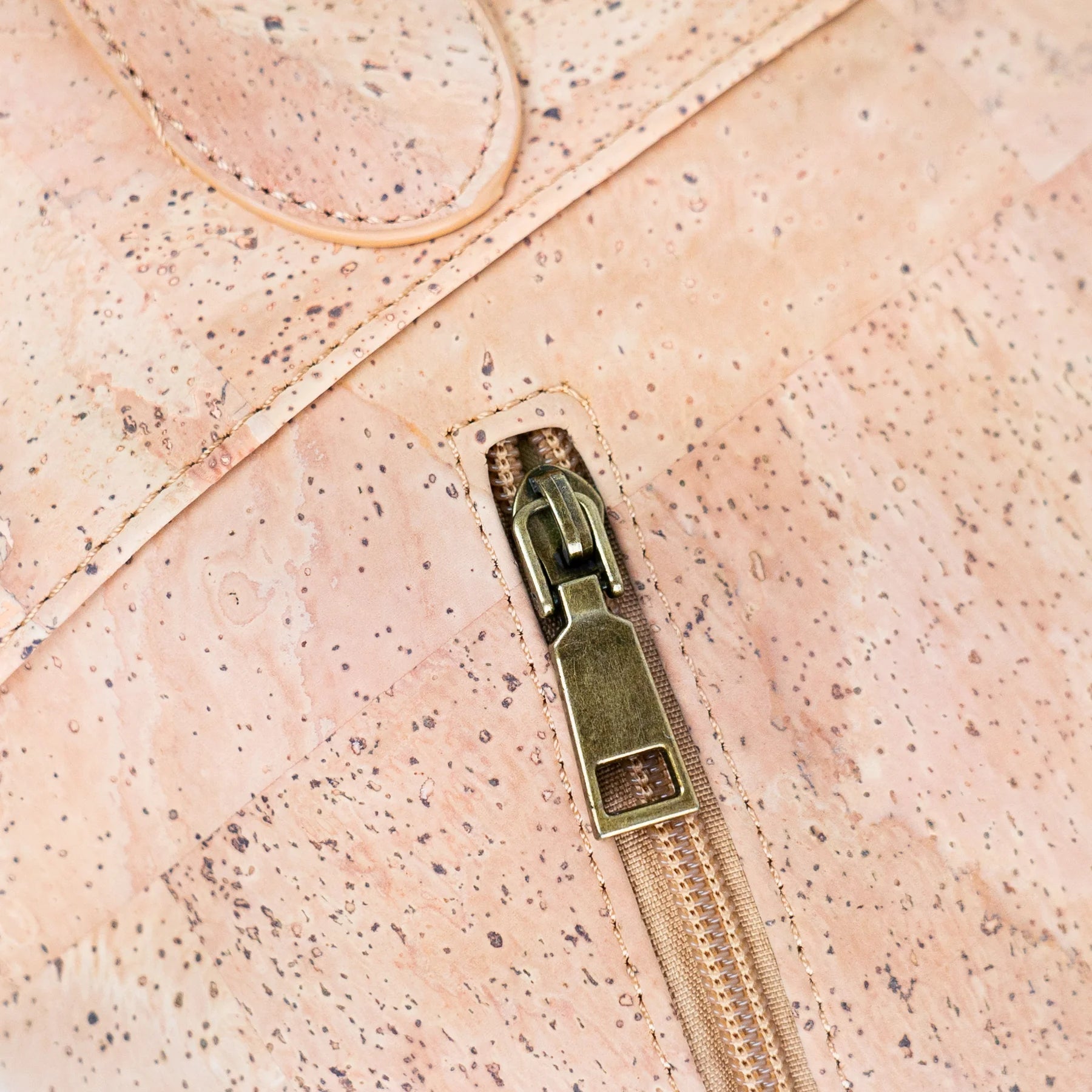 Close up of antique brass hardware on high end cork handbag