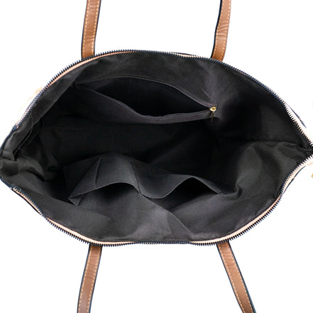 Interior view of cork tote showing zippered pockets and compartments