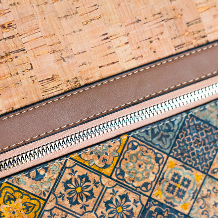Close-up of zipper detail on cork handbag with faux leather trim