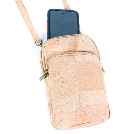 Cork crossbody bag with a phone in it on a white background