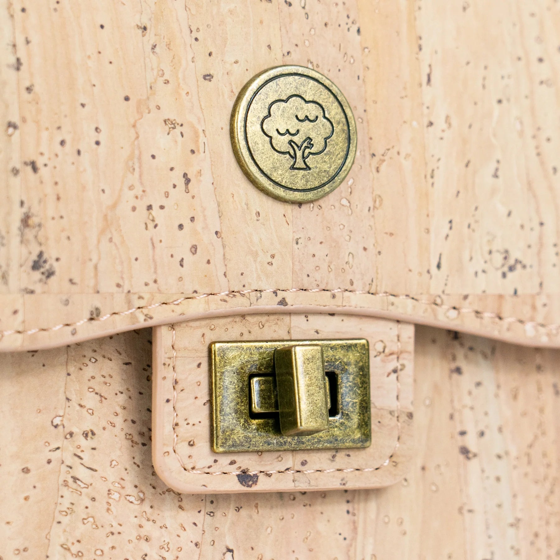 Antique brass twist lock close-up on cork phone bag