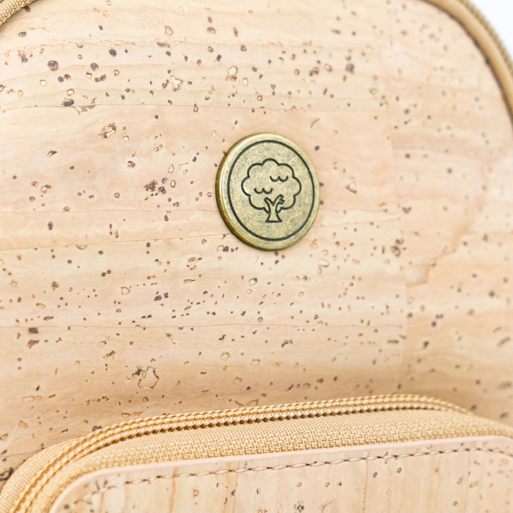Cork tree emblem detail on eco-friendly crossbody