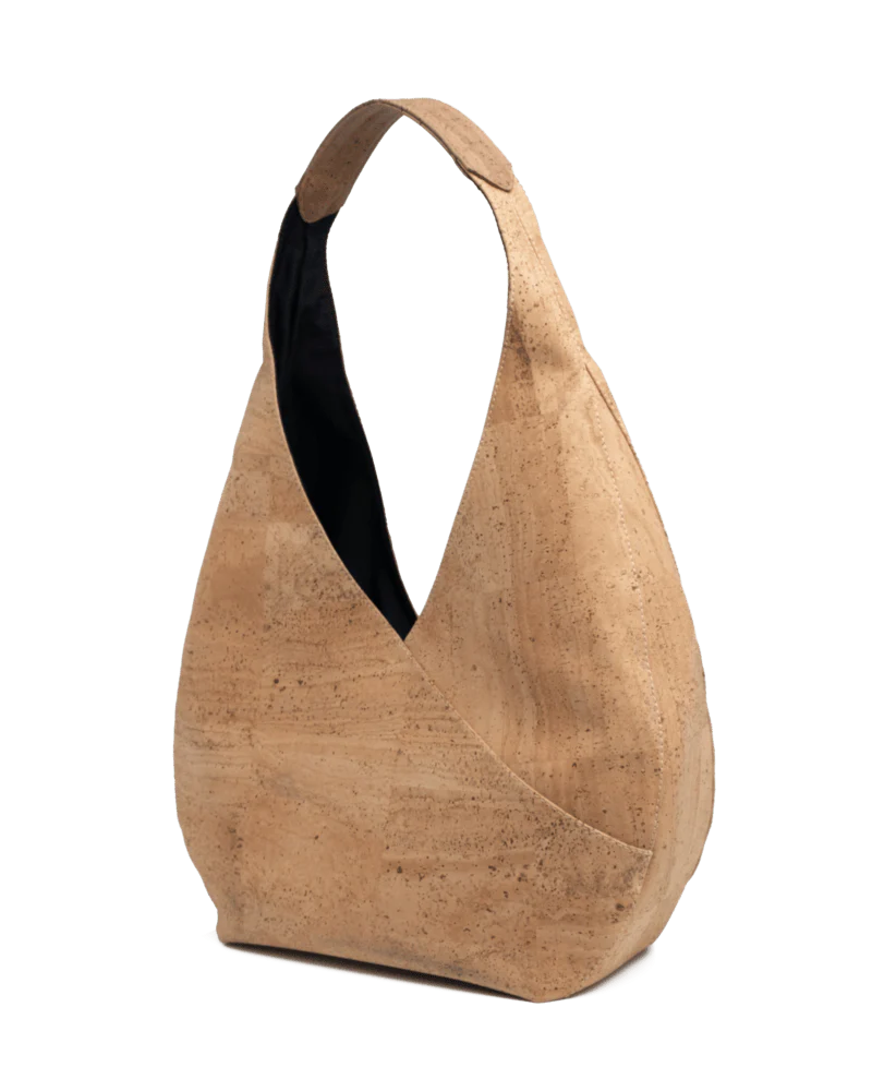 Side angle of sustainable cork shoulder bag showing modern curved shape