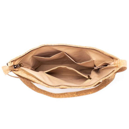 Inside of cork crossbody bag showing spacious compartments and zipper pocket