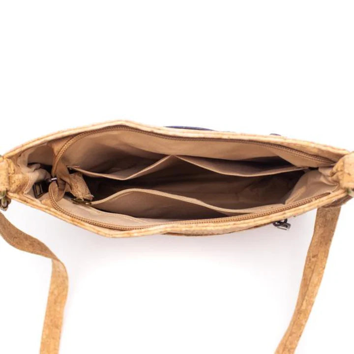 Interior view of brown cork crossbody with multiple compartments and zipper pocket