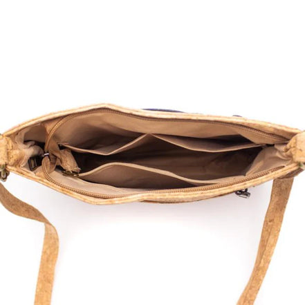 Interior view of brown cork crossbody with multiple compartments and zipper pocket