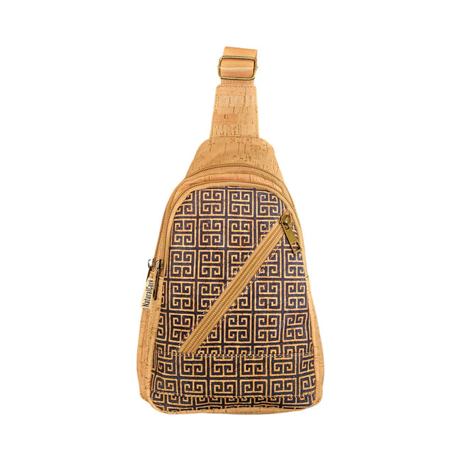 Front view of cork chest sling bag with navy Greek key pattern and slanted zipper pocket.