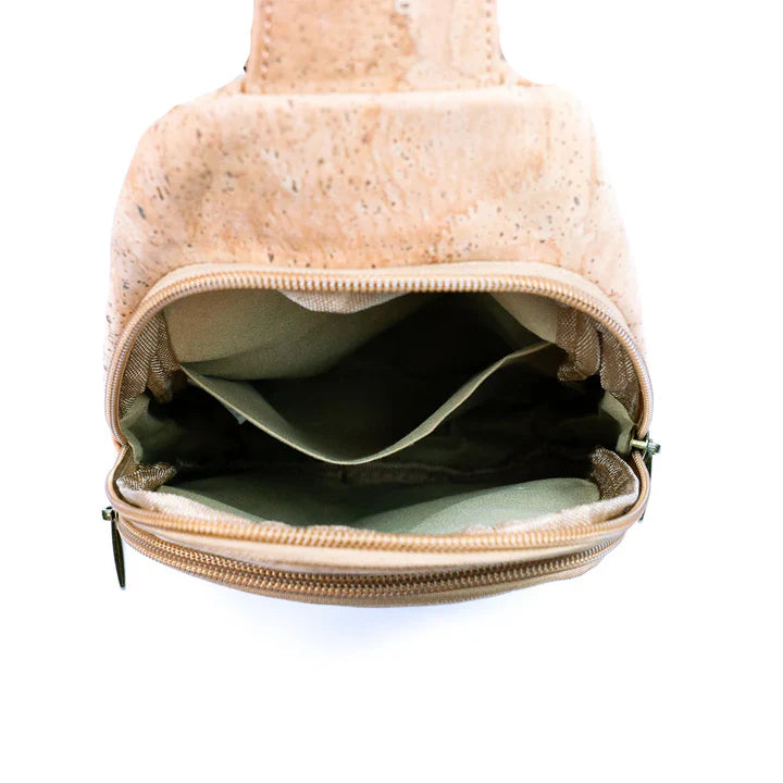 Interior of cork chest bag showing dual compartments and organized pocket layout.