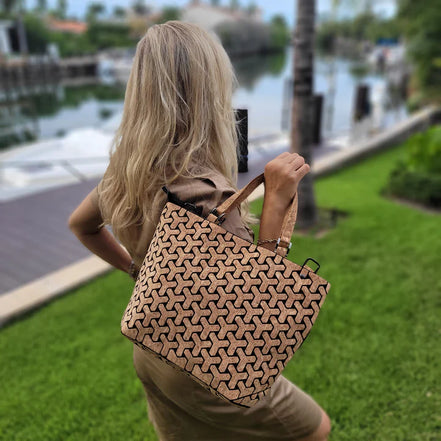 Vegan cork tote bag worn over shoulder outdoors with geometric design