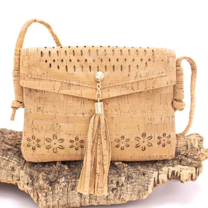 Cork tassel crossbody bag displayed on wood for natural styling