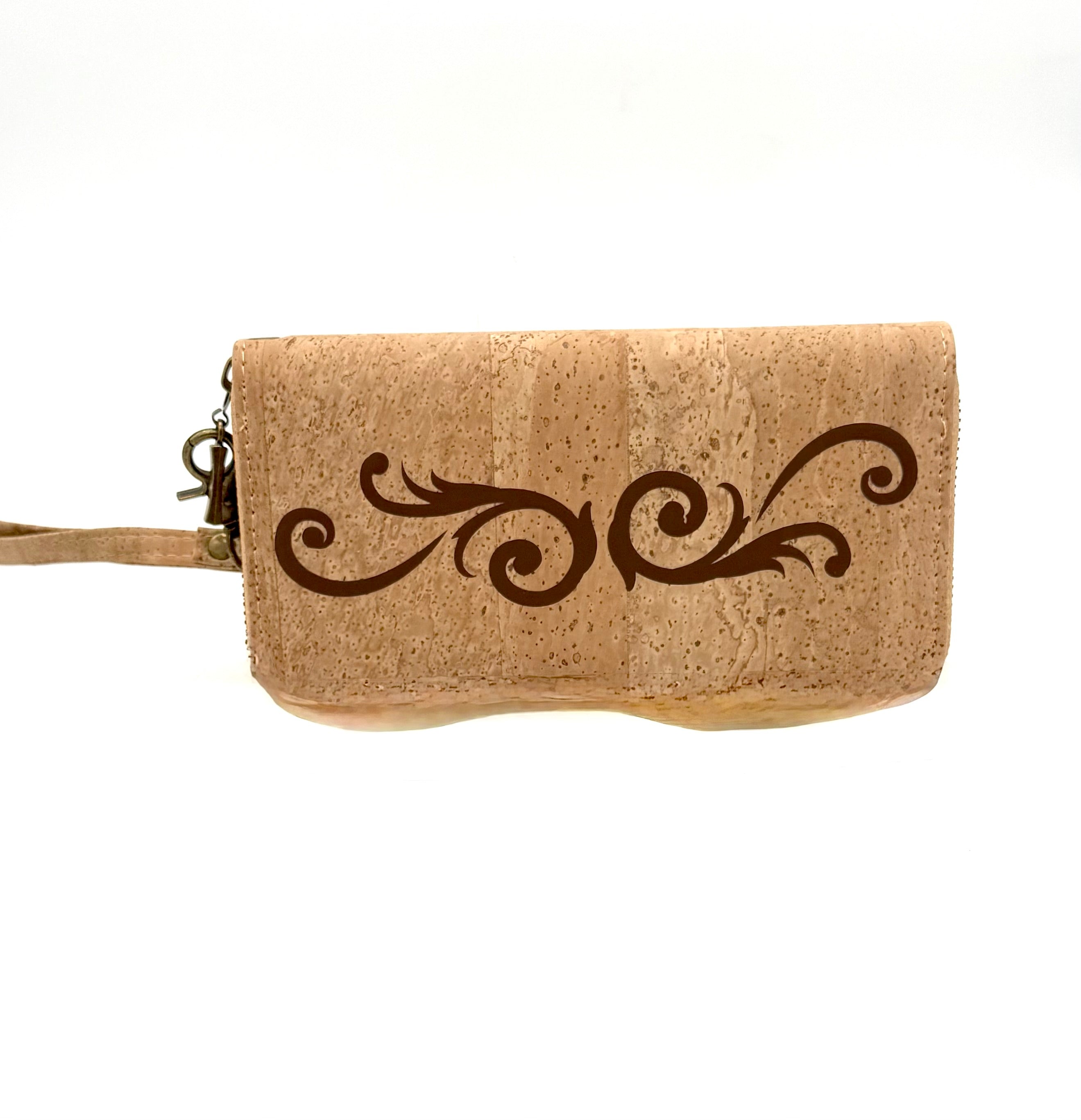 Cork wristlet with decorative scroll design on a white background
