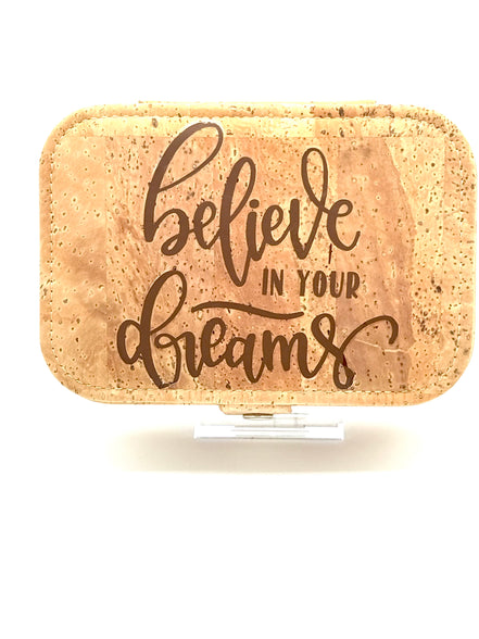 Cork jewelry box with 'believe in your dreams' text on a white background