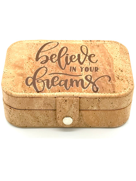 Cork jewelry box with 'believe in your dreams' text on a white background