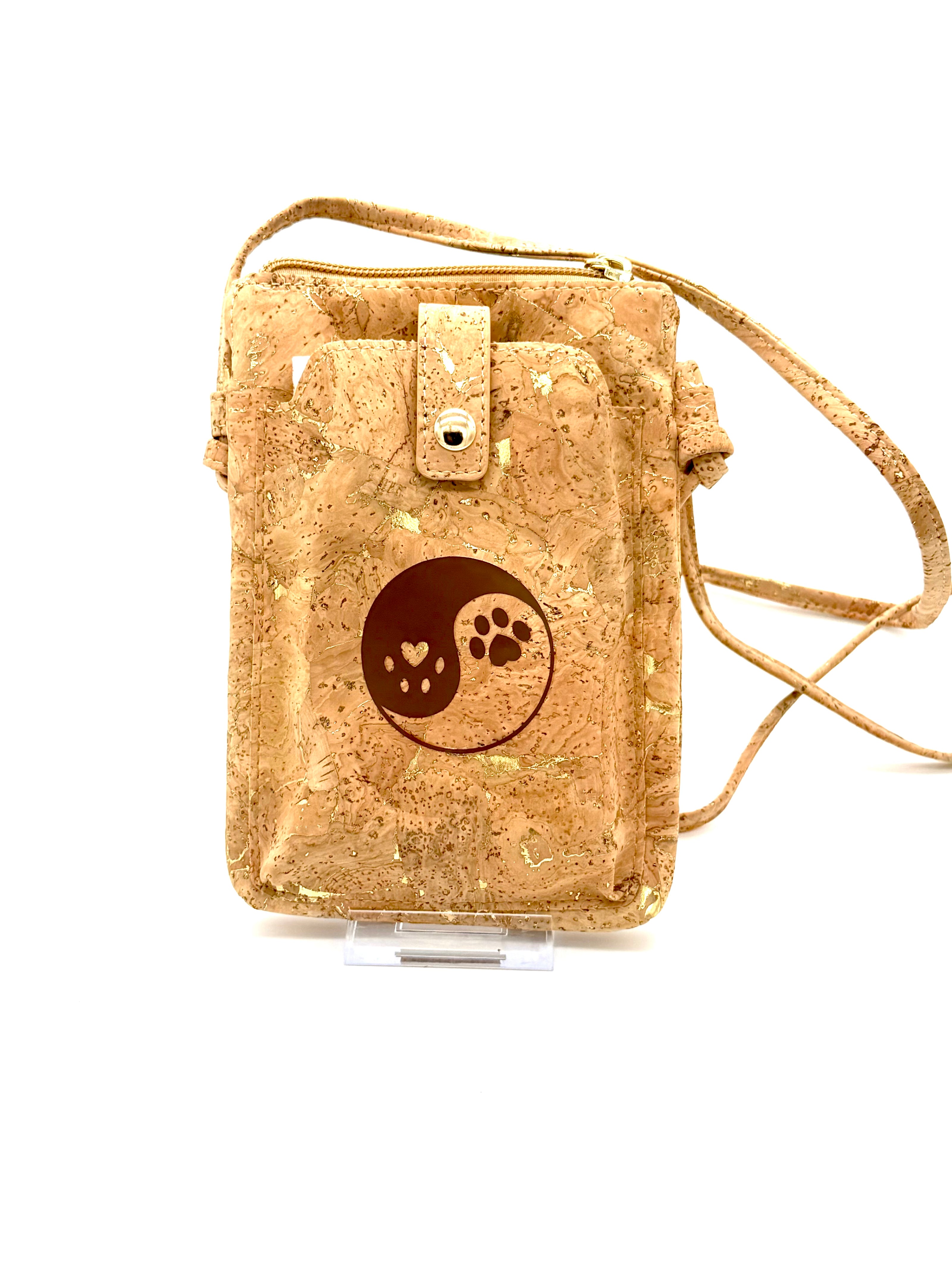 Cork pouch with a yin yang and paw print design on a white background