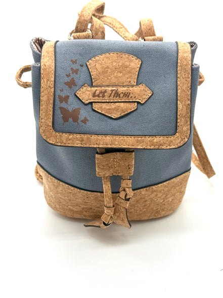Small backpack with cork accents and a blue canvas body on a white background