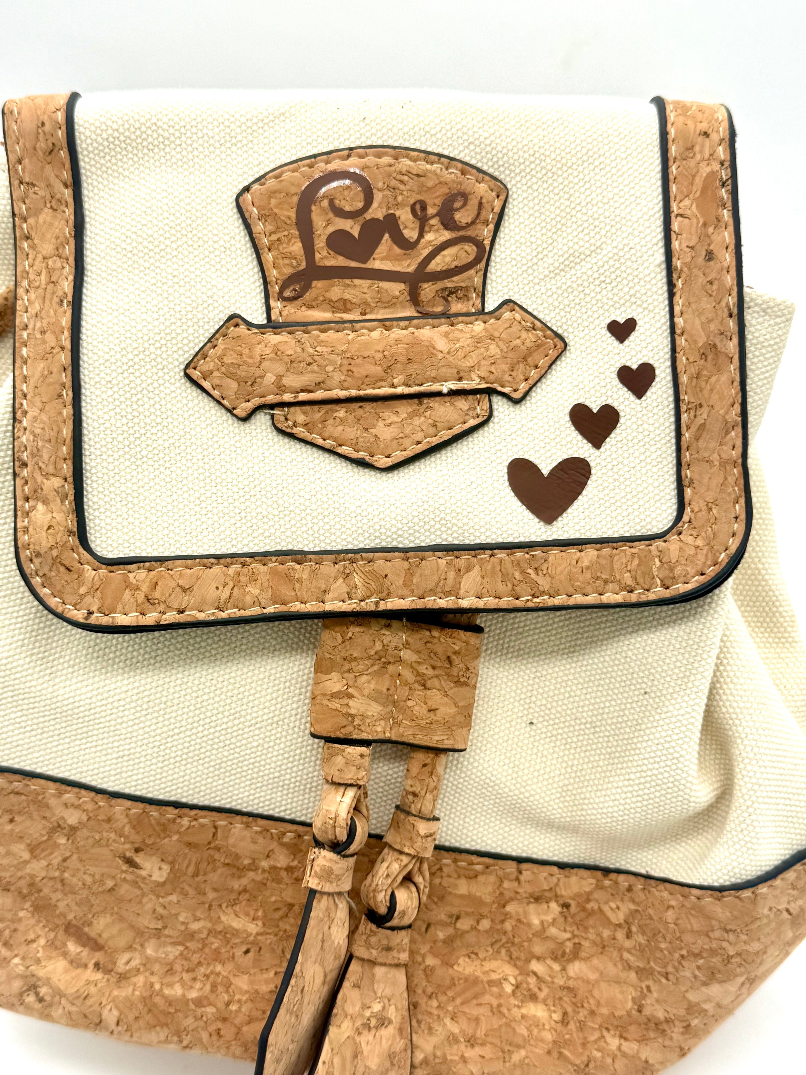 Small pouch with cork accents and 'Love' design on a white background