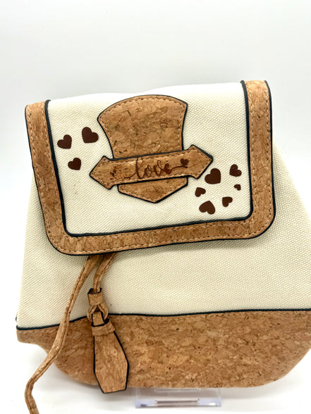Small bag with cork accents and decorative elements on a white background
