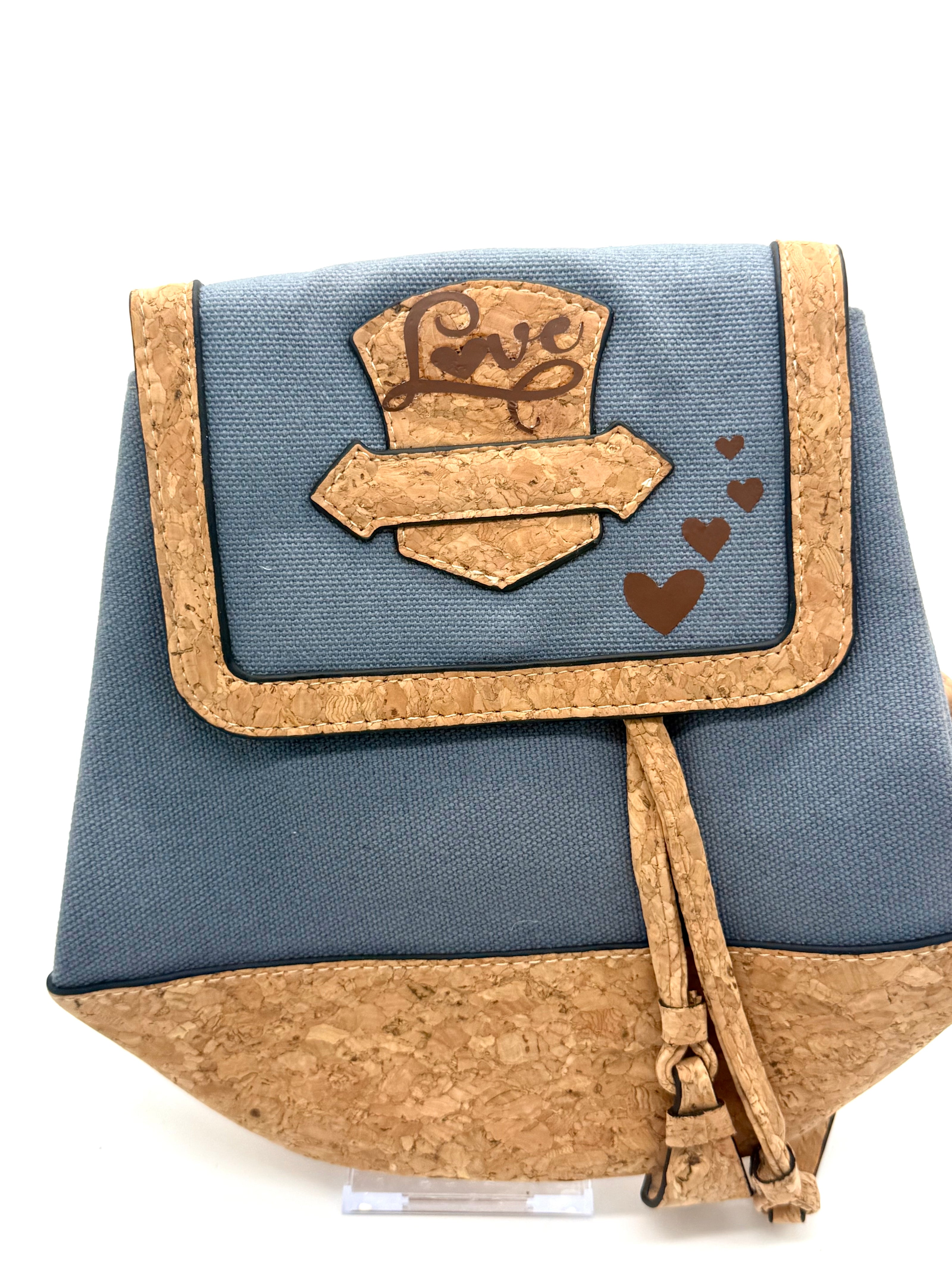 Small blue and cork bag with a decorative flap on a white background