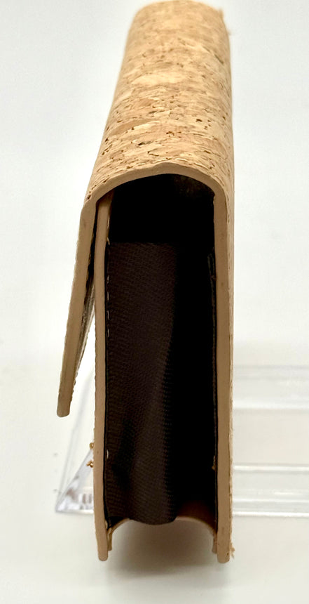 Side view Natural cork, accordion-style wallet with spacious interior that has 9 card pockets. 