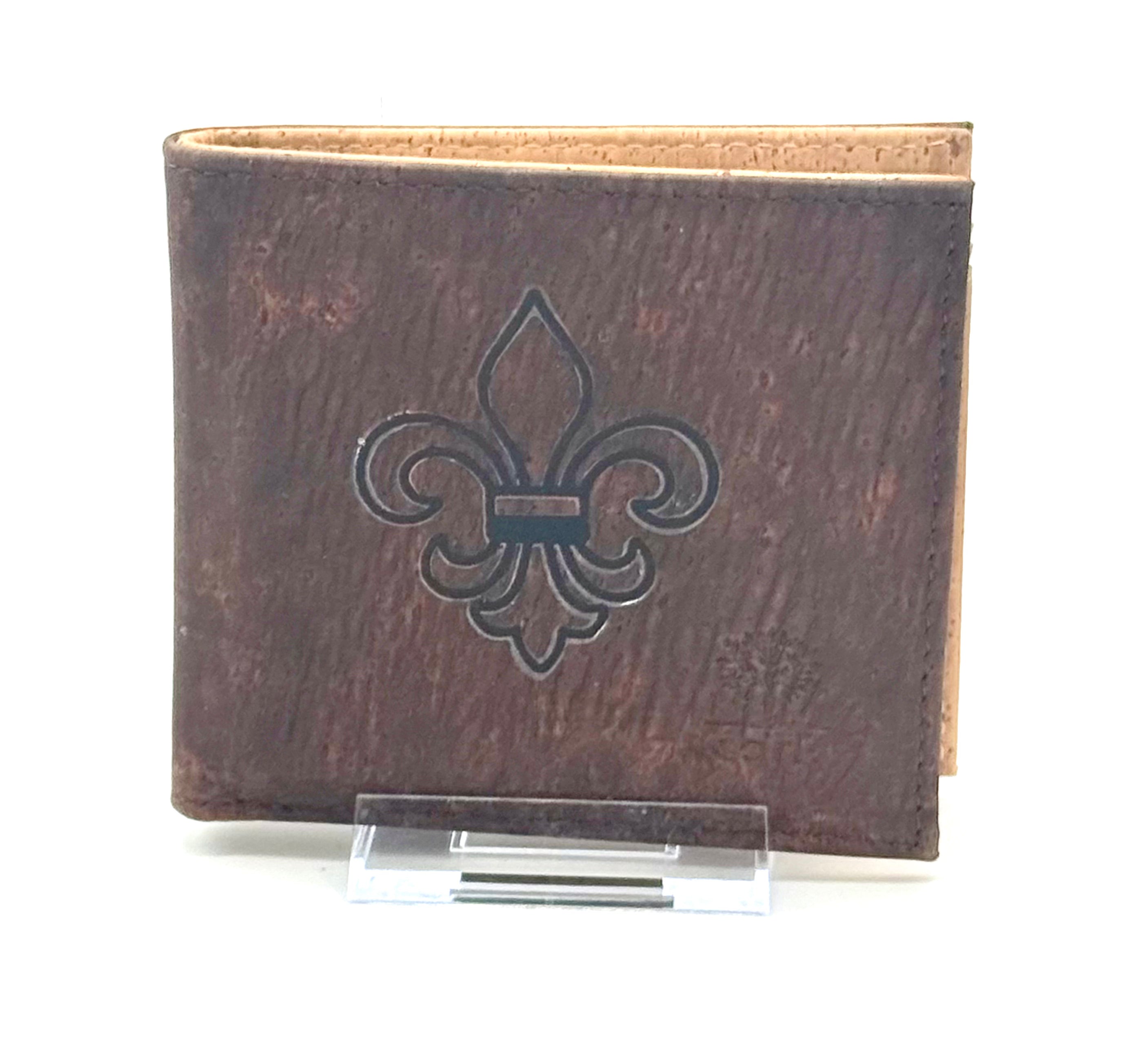 A slim, lightweight dark brown RFID protected bi-fold cork wallet that keeps your essentials organized without the bulk. fleur de lis