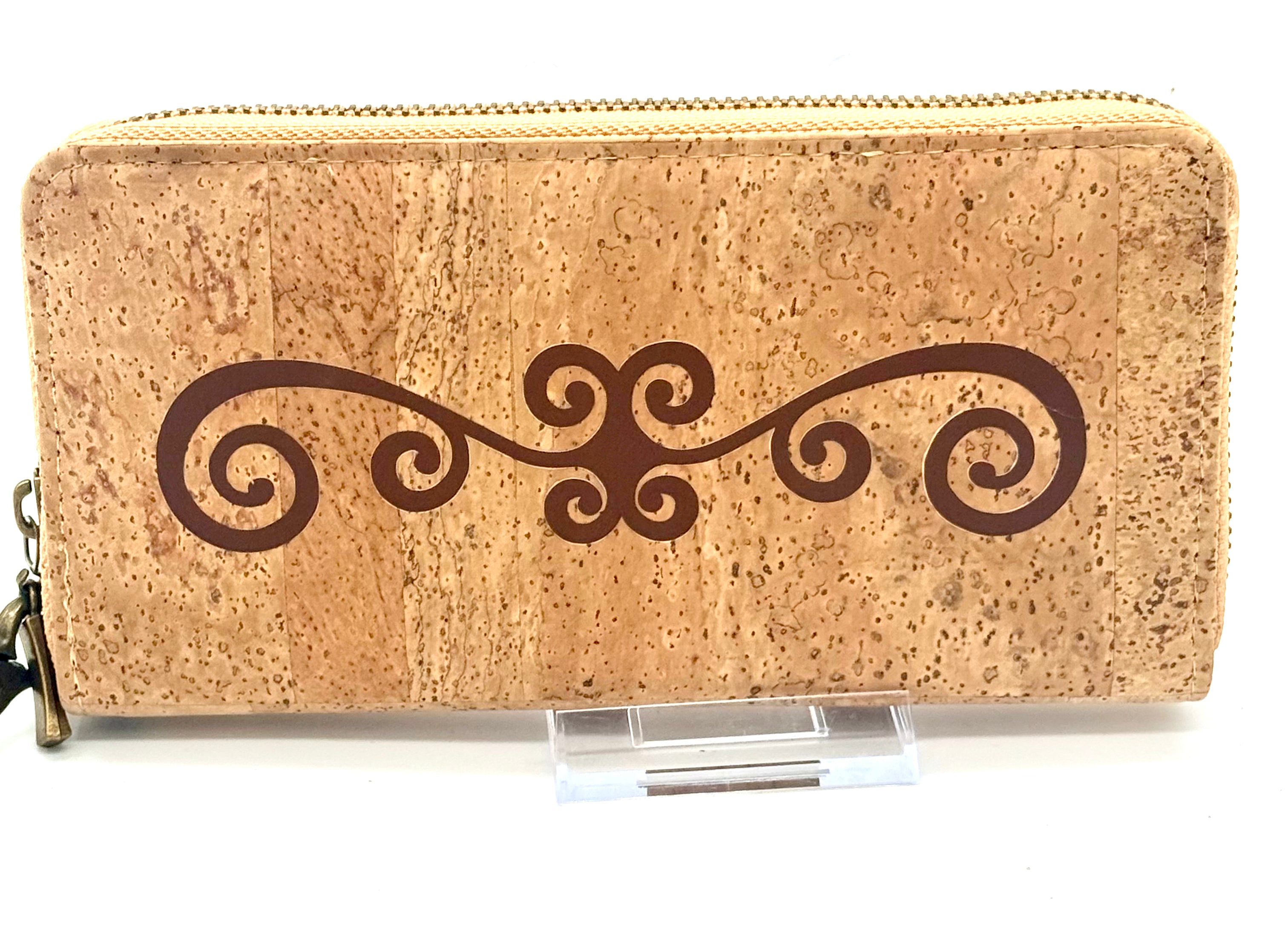 Cork wallet with decorative swirl design on a white background