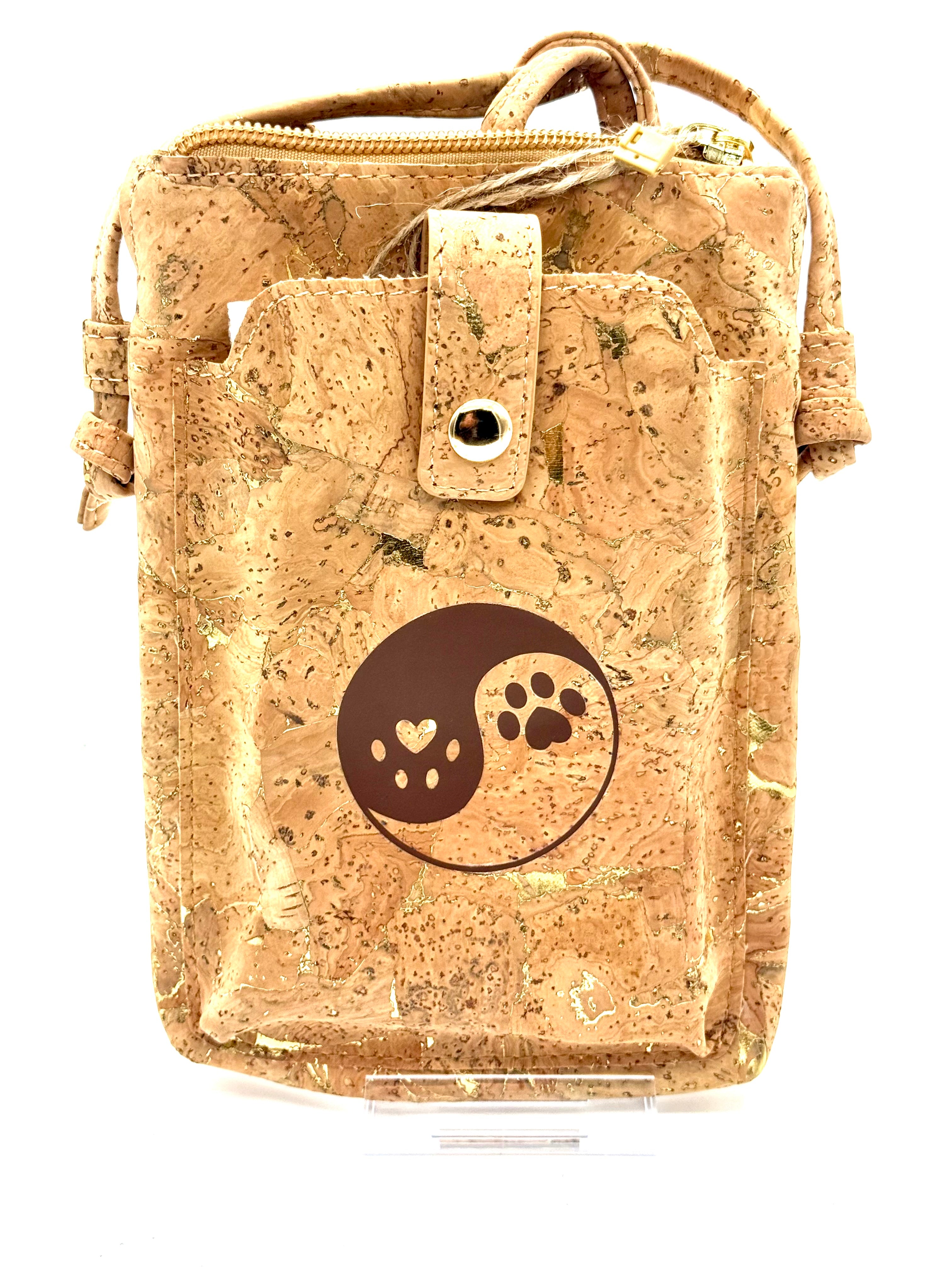 Cork pouch with a yin yang design featuring a heart and paw print on a white background
