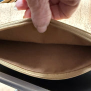 Close-up of a hand opening a cork bag