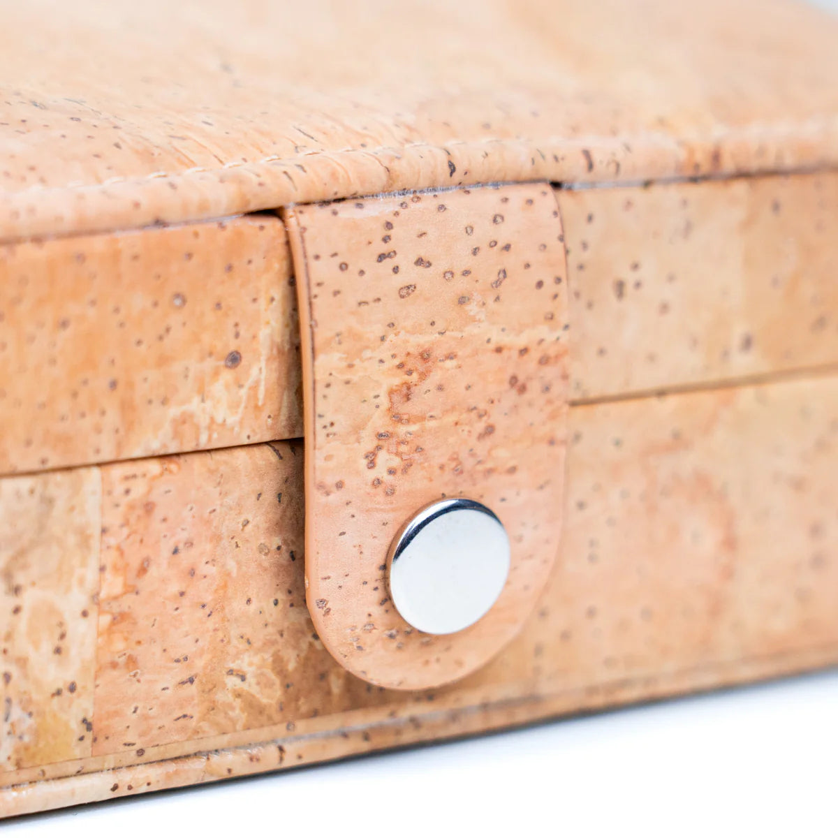 Close-up of snap closure on natural cork travel jewelry box‚Äù
