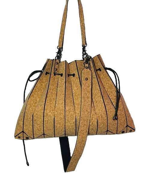 Side angle of cork tote showcasing laser cut pleats and drawstring detail