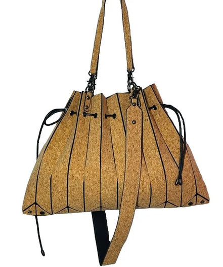 Side angle of cork tote showcasing laser cut pleats and drawstring detail