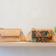 Boutique display with daisy and floral cork crossbody bags